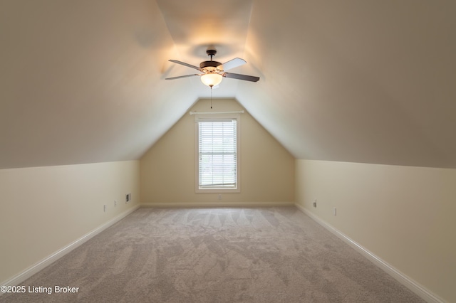 additional living space featuring ceiling fan, carpet, vaulted ceiling, and baseboards