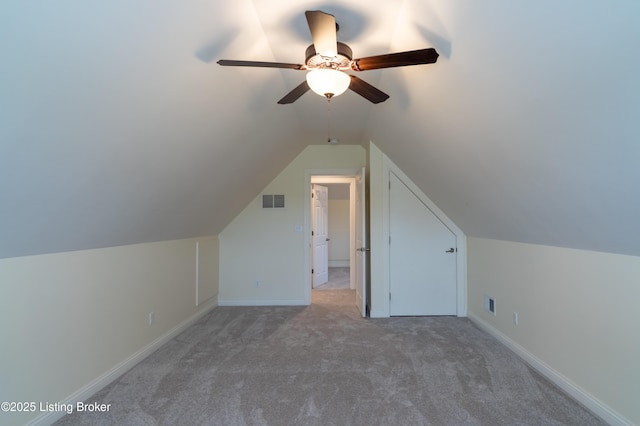 additional living space featuring vaulted ceiling, visible vents, ceiling fan, and light carpet