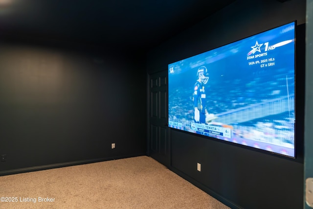 carpeted home theater with baseboards