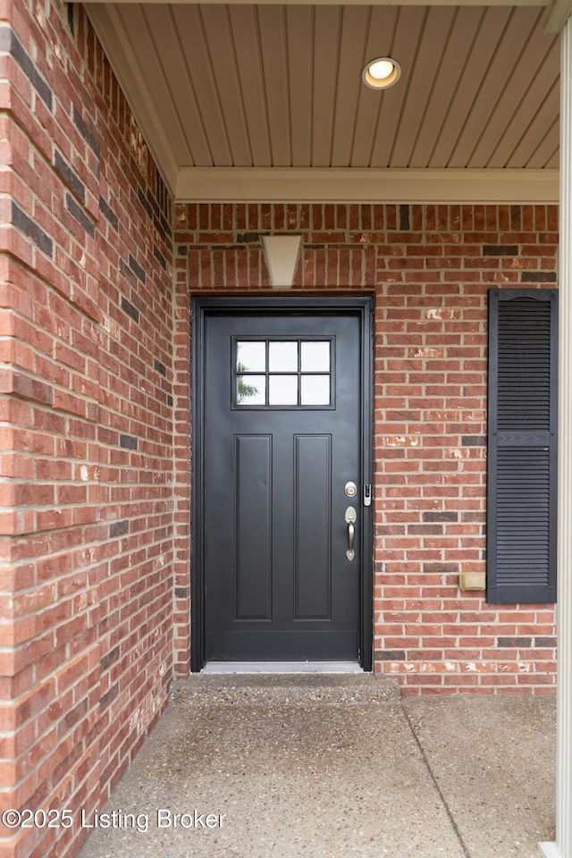 property entrance with brick siding