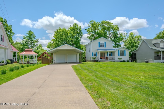 view of front of house featuring a garage, a front lawn, an outdoor structure, and a gazebo