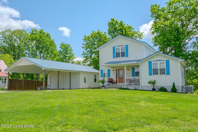 rear view of house with covered porch, central AC unit, a yard, a detached garage, and an outdoor structure