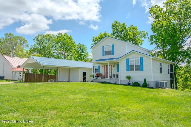 back of property featuring covered porch, central air condition unit, a yard, and a detached garage