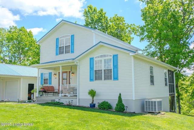 view of front of home featuring a porch, central AC, a front yard, and a garage
