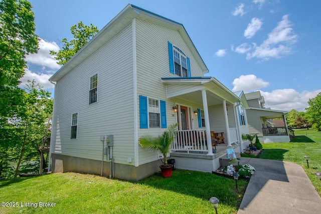 view of front of home with a porch and a front yard