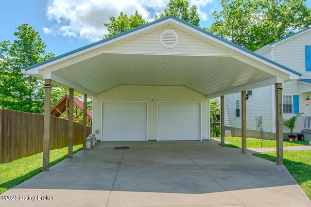 garage with a garage and fence