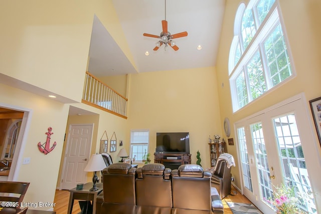living room with high vaulted ceiling, plenty of natural light, and ceiling fan