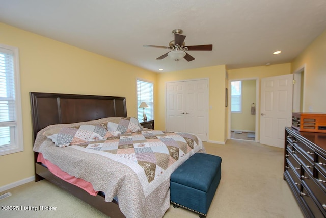 bedroom with light colored carpet, multiple windows, a closet, and recessed lighting