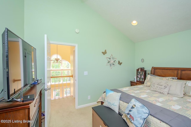 bedroom with high vaulted ceiling, carpet flooring, and baseboards