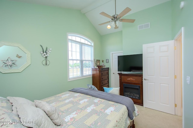 bedroom featuring light carpet, beam ceiling, high vaulted ceiling, a fireplace, and ceiling fan