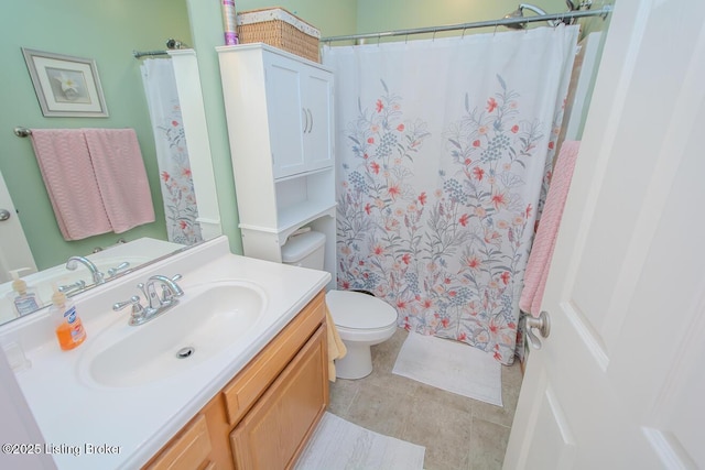 bathroom with vanity, toilet, a shower with curtain, and tile patterned flooring
