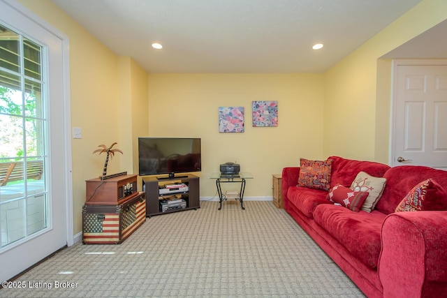 carpeted living area with baseboards and recessed lighting