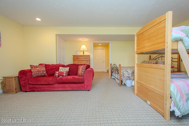 living area featuring light colored carpet and recessed lighting