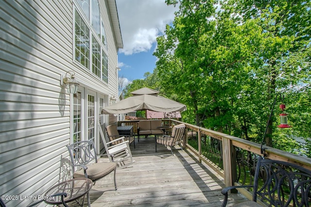 wooden terrace featuring an outdoor hangout area