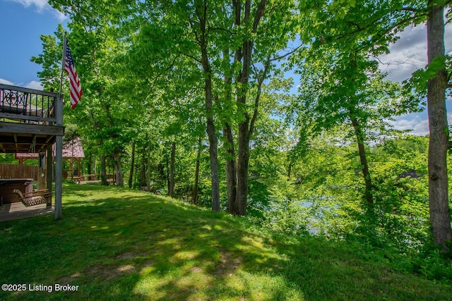 view of green lawn featuring a deck