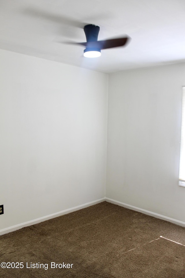 3023 Saint Dennis Ave, Louisville, KY 40216 - unfurnished room featuring baseboards, a ceiling fan, and dark carpet