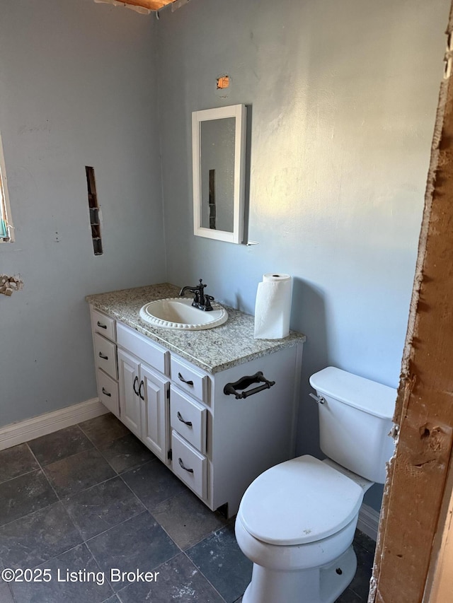 301 Coopers Point Rd, Leitchfield, KY 42754 - half bathroom featuring vanity, toilet, baseboards, and stone finish floors