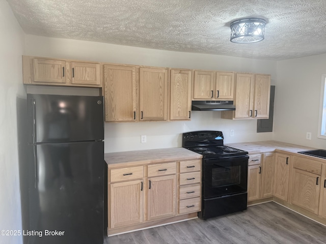 525 Leavette Ave, Leitchfield, KY 42754 - kitchen featuring black appliances, light brown cabinets, under cabinet range hood, a textured ceiling, and light wood finished floors
