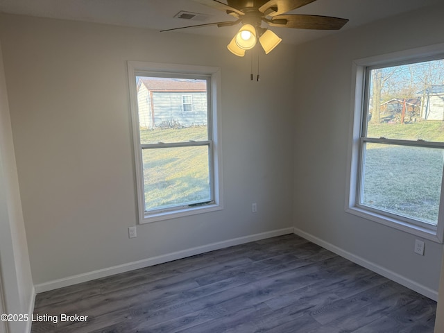 525 Leavette Ave, Leitchfield, KY 42754 - empty room featuring dark wood-style floors, plenty of natural light, a ceiling fan, and baseboards