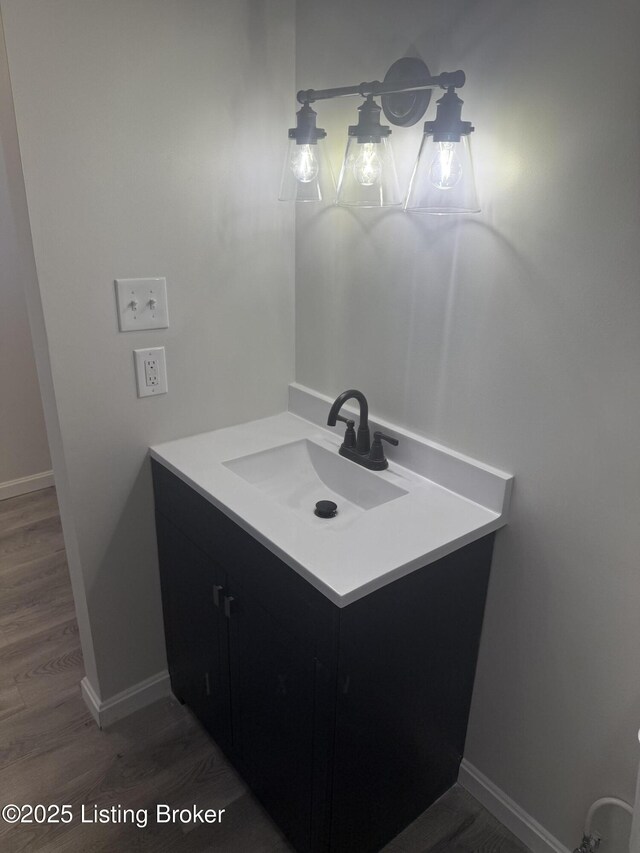 525 Leavette Ave, Leitchfield, KY 42754 - bathroom featuring wood finished floors, vanity, and baseboards