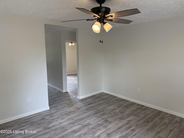 525 Leavette Ave, Leitchfield, KY 42754 - unfurnished room with a textured ceiling, wood finished floors, ceiling fan, and baseboards