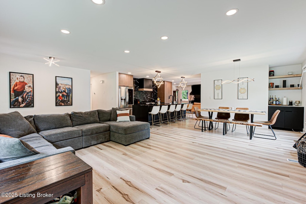 2527 Windsor Forest Dr, Louisville, KY 40272 - living room featuring light wood-type flooring, a chandelier, and recessed lighting