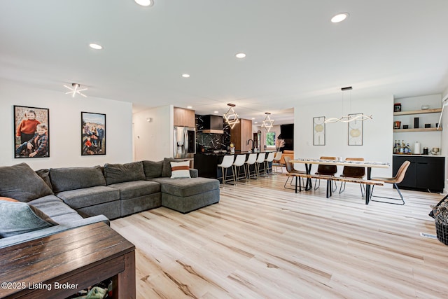 2527 Windsor Forest Dr, Louisville, KY 40272 - living room featuring light wood-type flooring, a chandelier, and recessed lighting