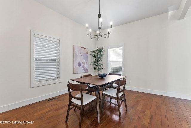 dining area with a chandelier, baseboards, dark wood-style floors, and visible vents