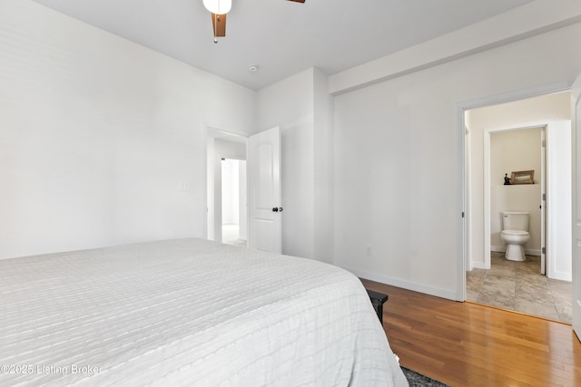bedroom with ensuite bath, ceiling fan, and wood finished floors