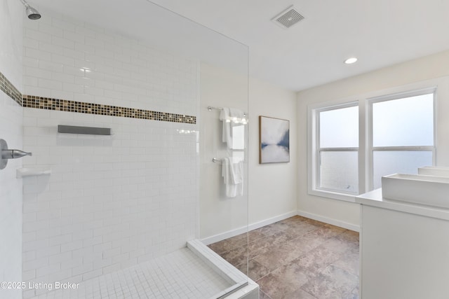 full bath with vanity, visible vents, recessed lighting, baseboards, and a tile shower