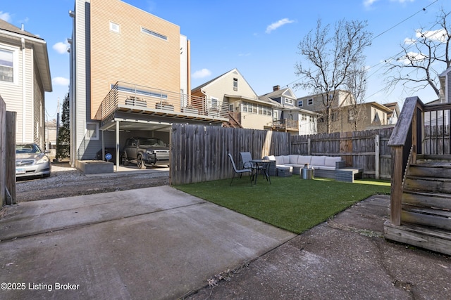 view of yard featuring stairway, a residential view, outdoor lounge area, and fence