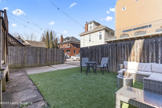 view of yard featuring a fenced backyard, a patio, and an outdoor living space