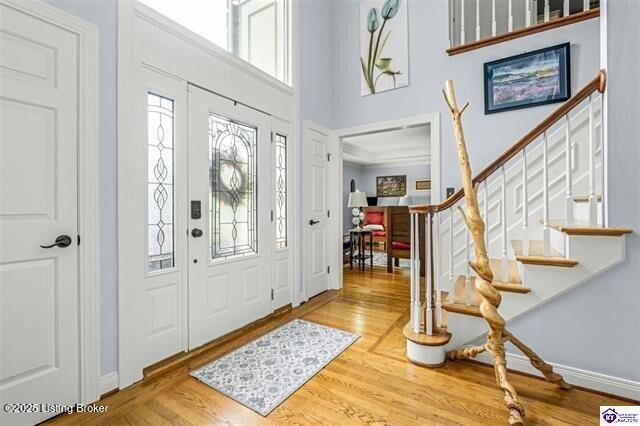 3507 Bridgegate Ct, Louisville, KY 40272 - foyer featuring healthy amount of natural light, stairs, wood finished floors, a towering ceiling, and baseboards