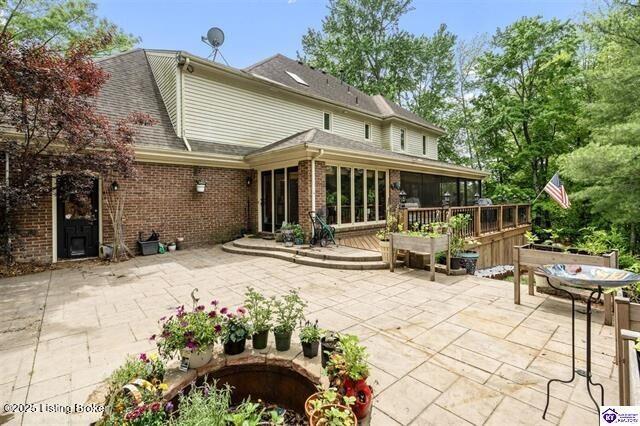 3507 Bridgegate Ct, Louisville, KY 40272 - rear view of property with a patio area, brick siding, a sunroom, a shingled roof, and a wooden deck