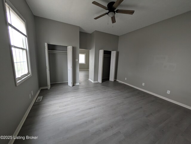 511 Marret Ave, Louisville, KY 40208 - unfurnished bedroom with baseboards, wood finished floors, two closets, and a ceiling fan