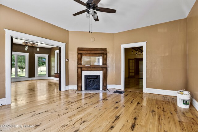 1836 Ellis Rd, Eminence, KY 40019 - unfurnished living room featuring hardwood / wood-style floors, ceiling fan, a fireplace, and baseboards