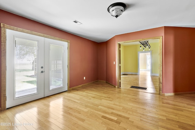 1836 Ellis Rd, Eminence, KY 40019 - empty room featuring french doors, plenty of natural light, light wood-style floors, and baseboards