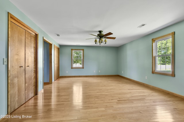 1836 Ellis Rd, Eminence, KY 40019 - unfurnished bedroom with light wood finished floors, multiple closets, baseboards, and ceiling fan