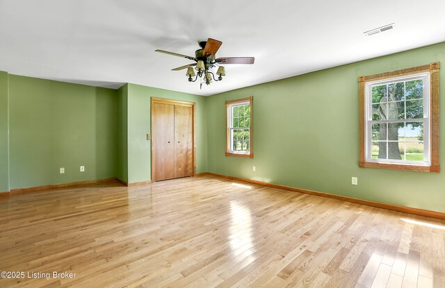 1836 Ellis Rd, Eminence, KY 40019 - unfurnished bedroom with baseboards, light wood-style flooring, a closet, and a ceiling fan