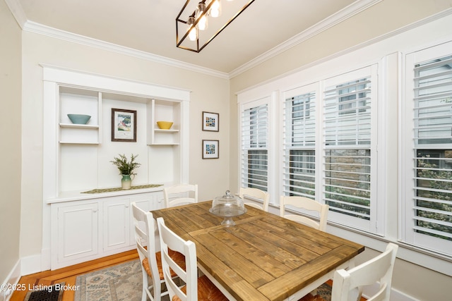2104 Lauderdale Rd, Louisville, KY 40205 - dining area with light wood finished floors, ornamental molding, and built in shelves