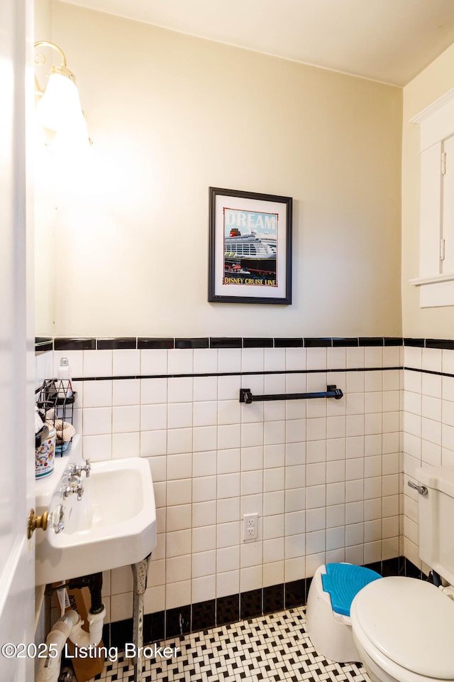 2104 Lauderdale Rd, Louisville, KY 40205 - bathroom featuring a sink, tile walls, toilet, tile patterned flooring, and wainscoting