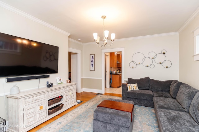 2104 Lauderdale Rd, Louisville, KY 40205 - living room featuring baseboards, a notable chandelier, ornamental molding, and light wood-style flooring