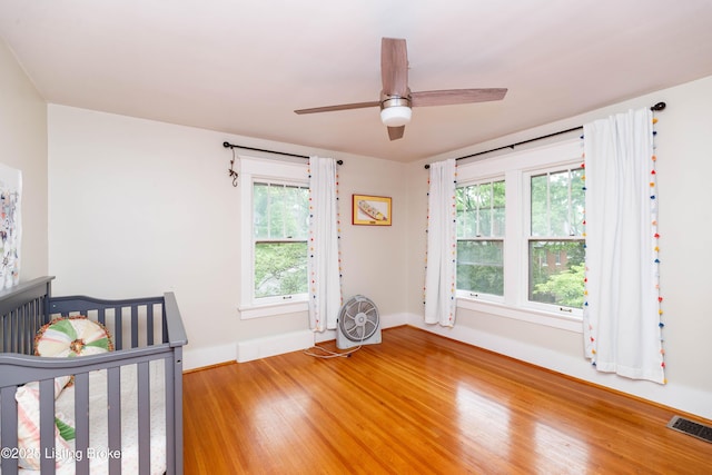 2104 Lauderdale Rd, Louisville, KY 40205 - unfurnished bedroom with light wood finished floors, multiple windows, visible vents, and baseboards