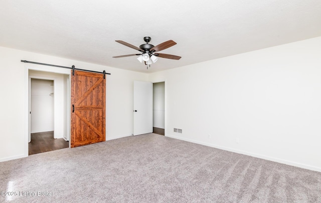 4002 Ciremos Ter, Louisville, KY 40241 - unfurnished bedroom with carpet floors, a barn door, baseboards, and ceiling fan