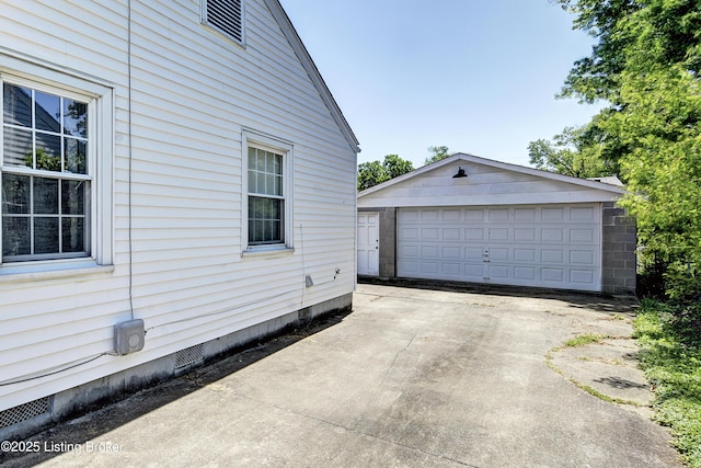 view of home's exterior featuring crawl space, an outbuilding, and a garage