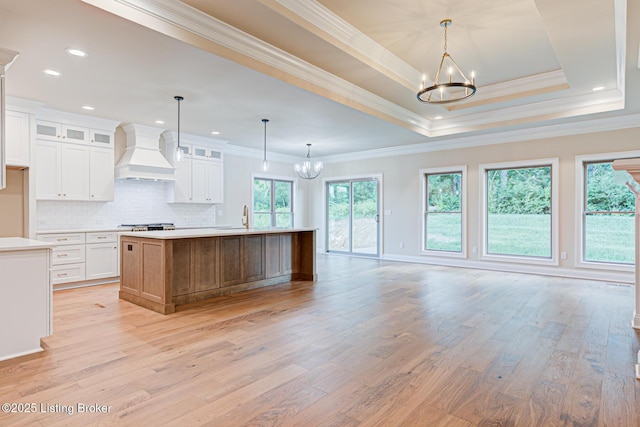2003 Lakeview Villas Pl, Louisville, KY 40245 - kitchen featuring a chandelier, custom exhaust hood, plenty of natural light, light wood finished floors, and ornamental molding