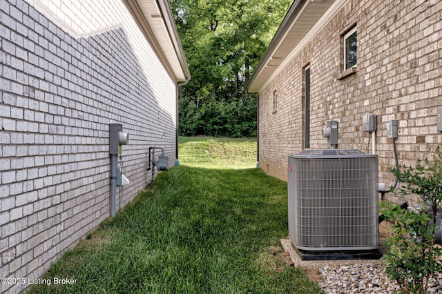2003 Lakeview Villas Pl, Louisville, KY 40245 - view of property exterior with central AC, a yard, and brick siding