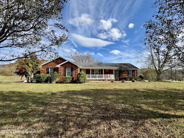 ranch-style house with a front lawn, brick siding, and covered porch