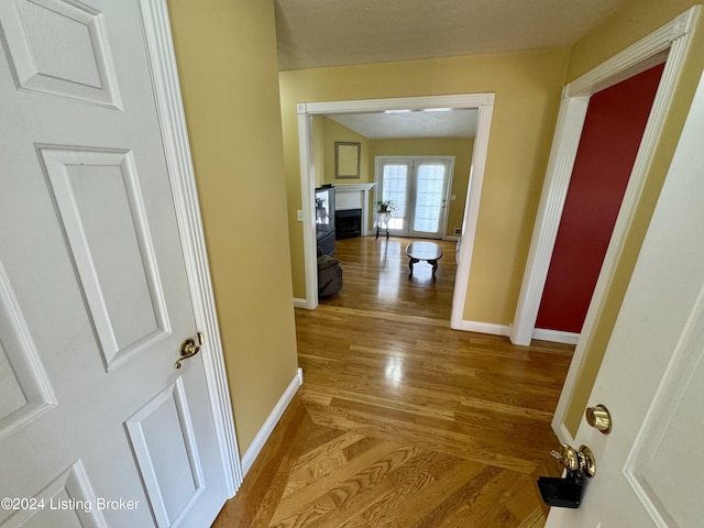 hallway with wood finished floors and baseboards