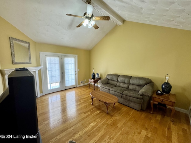 living area with light wood-style flooring, vaulted ceiling with beams, visible vents, baseboards, and ceiling fan